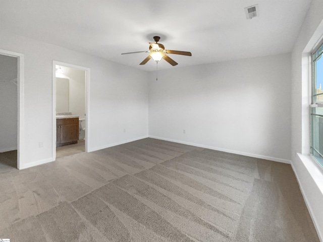 spare room featuring ceiling fan and carpet flooring