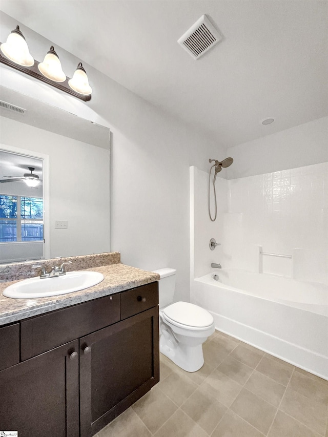 full bathroom featuring ceiling fan, vanity, washtub / shower combination, and toilet