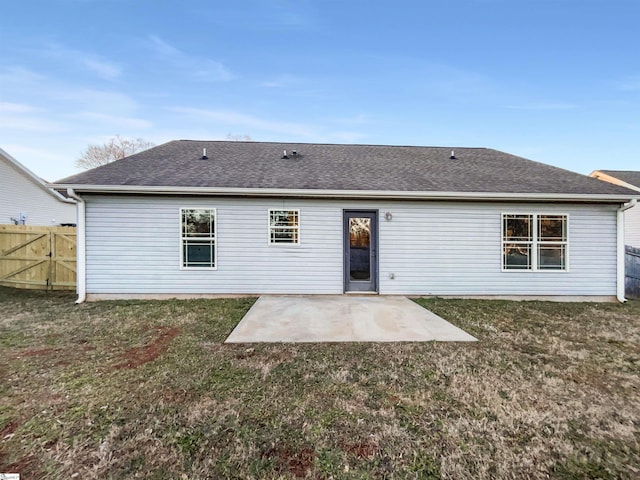 rear view of property featuring a yard and a patio