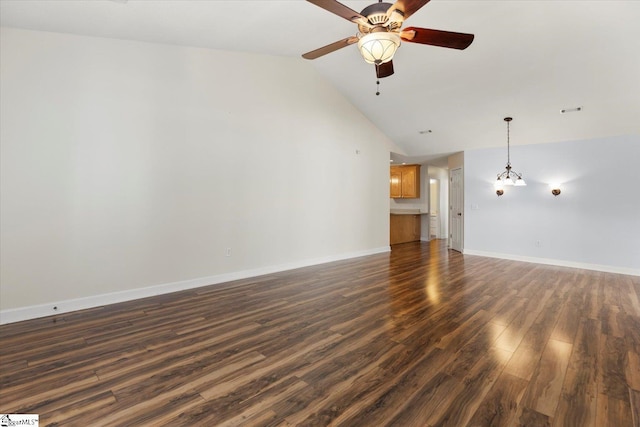 unfurnished living room with ceiling fan with notable chandelier, high vaulted ceiling, and dark hardwood / wood-style flooring