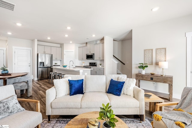 living room with sink and dark hardwood / wood-style floors