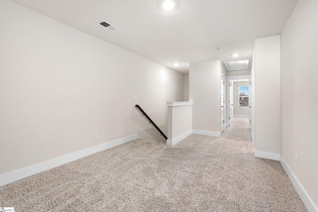 hallway featuring light carpet