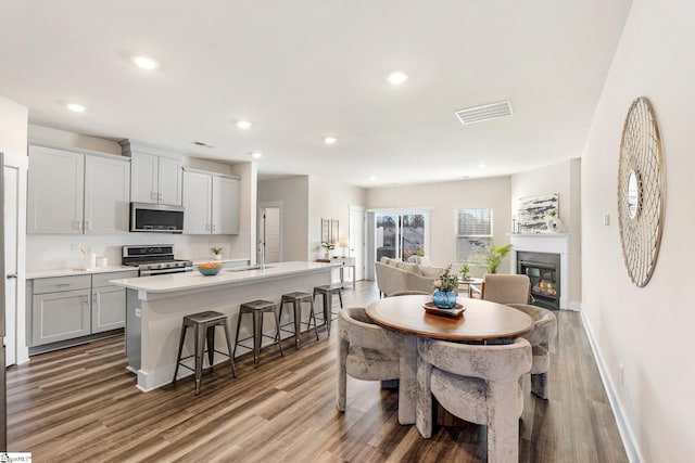 dining space with hardwood / wood-style flooring and sink