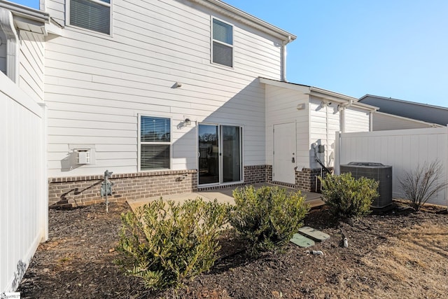 rear view of property featuring cooling unit