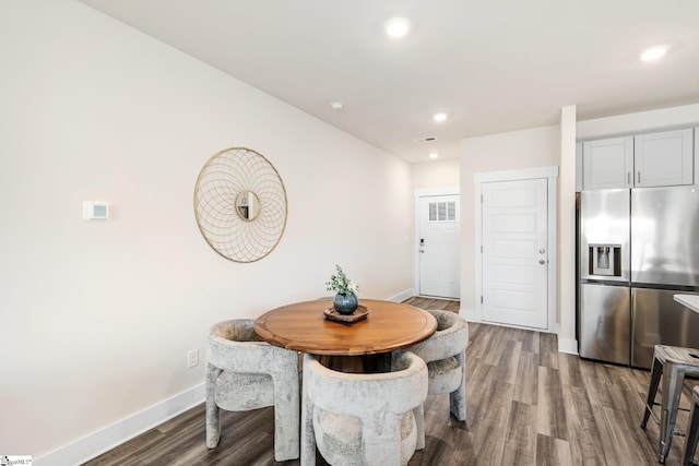 dining space with wood-type flooring