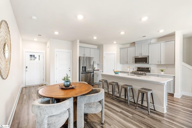 dining area with light wood-type flooring and sink