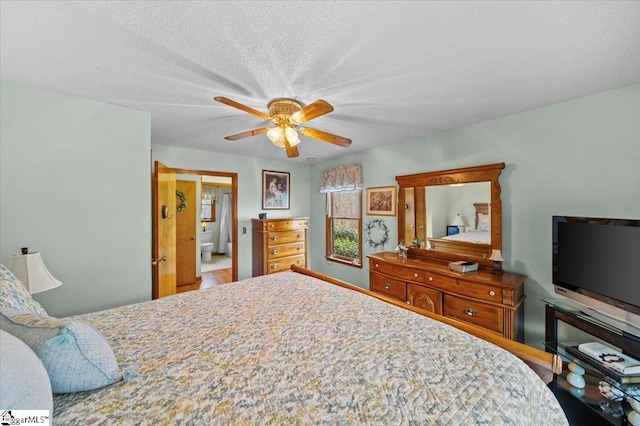 bedroom with ceiling fan and a textured ceiling