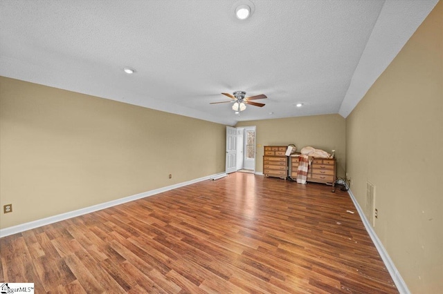 unfurnished living room with a textured ceiling, ceiling fan, and hardwood / wood-style floors