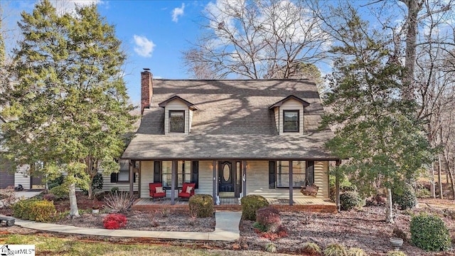 new england style home featuring a porch