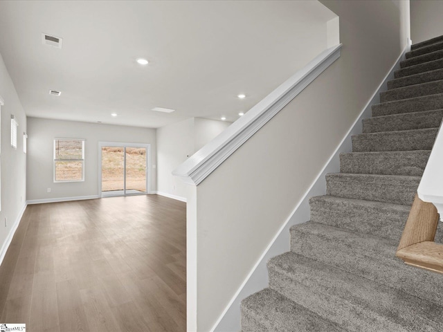 stairs with hardwood / wood-style floors