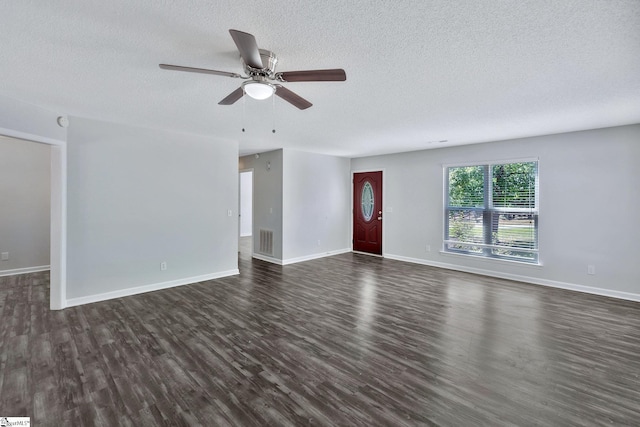 unfurnished living room with dark hardwood / wood-style flooring, a textured ceiling, and ceiling fan