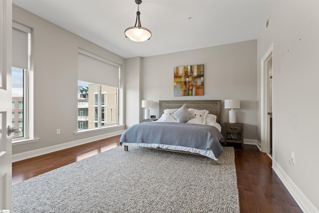 bedroom with dark hardwood / wood-style floors