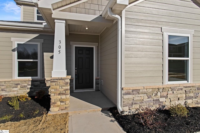 doorway to property featuring covered porch