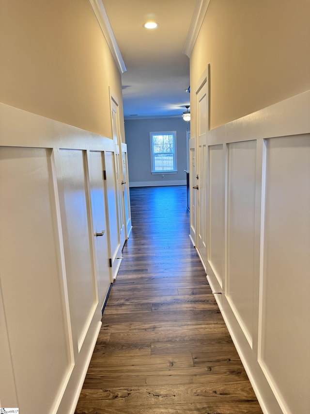 hallway featuring ornamental molding and dark wood-type flooring