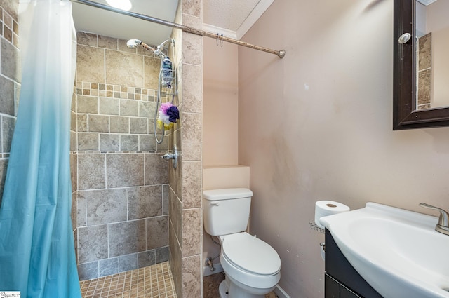 bathroom with toilet, walk in shower, vanity, ornamental molding, and a textured ceiling