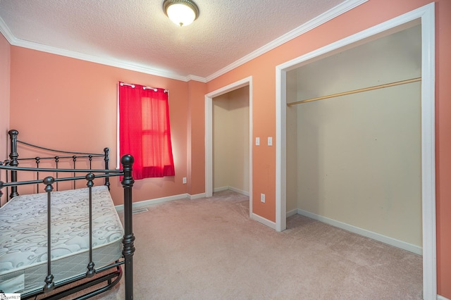 carpeted bedroom featuring a textured ceiling and ornamental molding