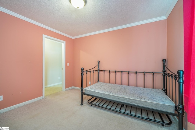 bedroom featuring a textured ceiling, ornamental molding, and light carpet