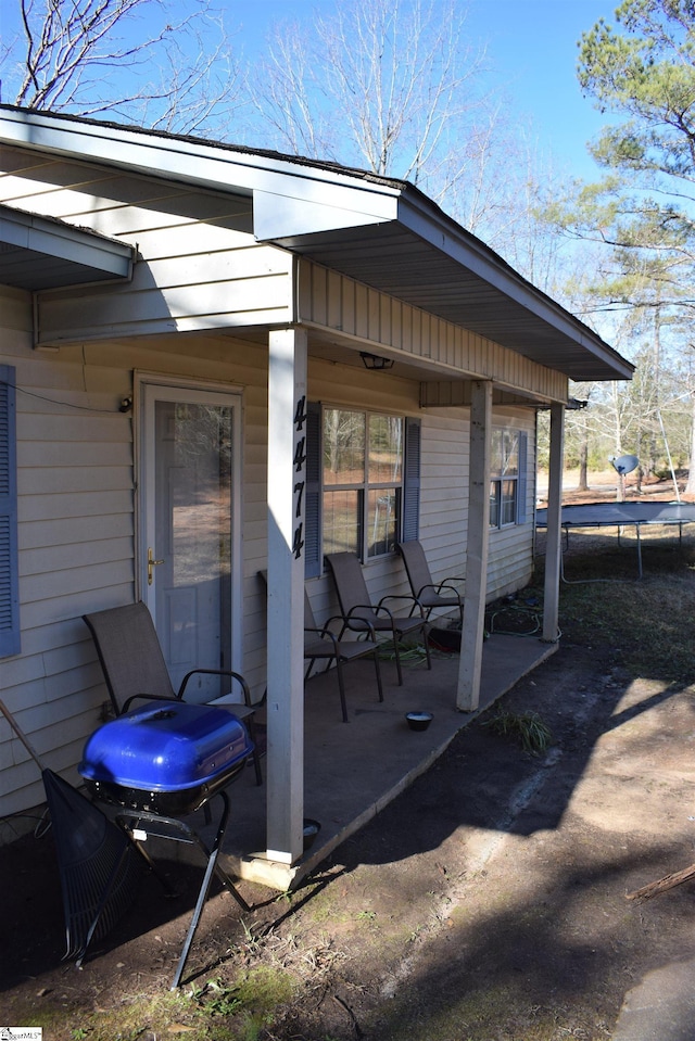 view of patio with area for grilling and a trampoline