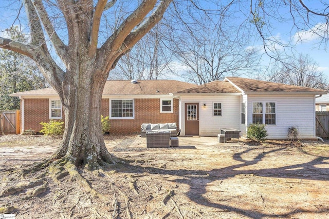 rear view of house with a patio area and an outdoor living space