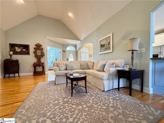 living room featuring light hardwood / wood-style floors and vaulted ceiling