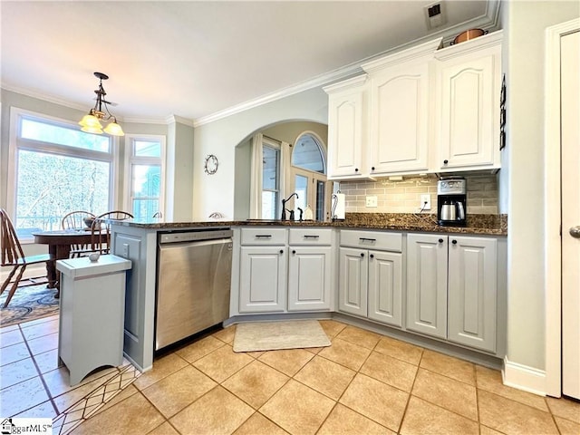 kitchen featuring decorative light fixtures, white cabinetry, dishwasher, dark stone counters, and crown molding