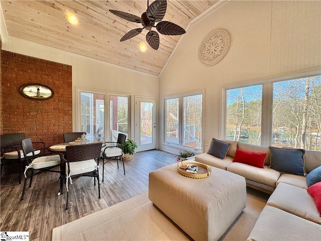 sunroom with ceiling fan, vaulted ceiling, and wooden ceiling