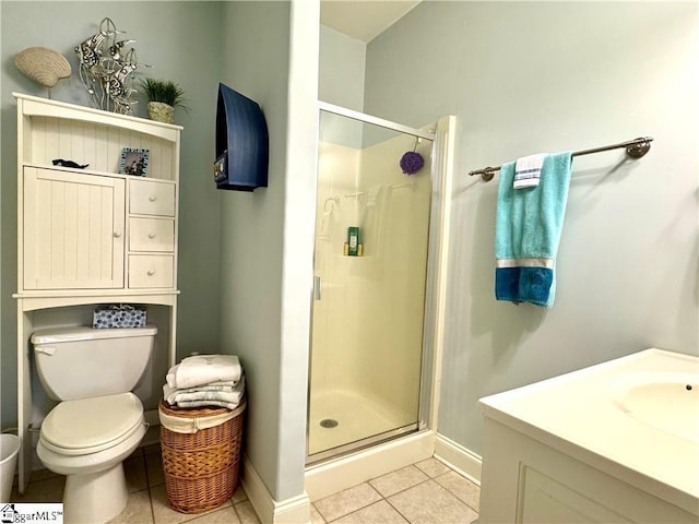 bathroom with toilet, tile patterned flooring, a shower with shower door, and vanity