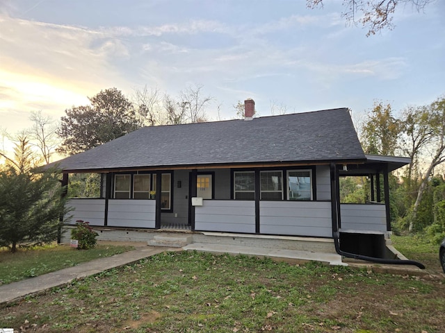 view of front facade featuring a porch and a yard