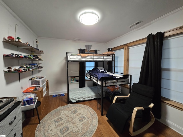 bedroom featuring ornamental molding and hardwood / wood-style flooring