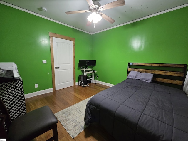 bedroom with ceiling fan, hardwood / wood-style flooring, and crown molding