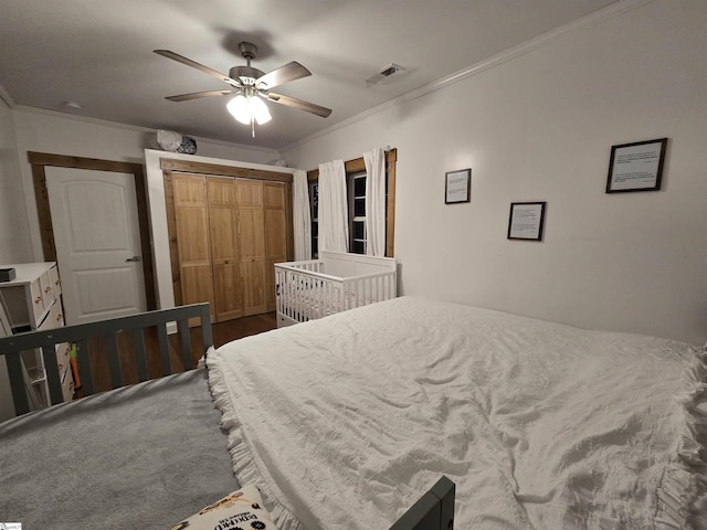 bedroom featuring ceiling fan, a closet, and crown molding