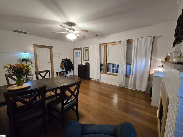 dining space with ceiling fan, ornamental molding, and dark hardwood / wood-style floors