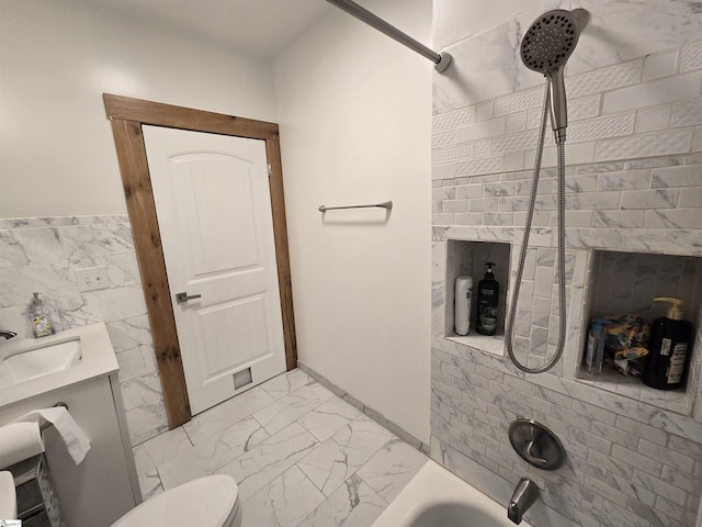 full bathroom with tile walls, shower / bathtub combination, vanity, and toilet