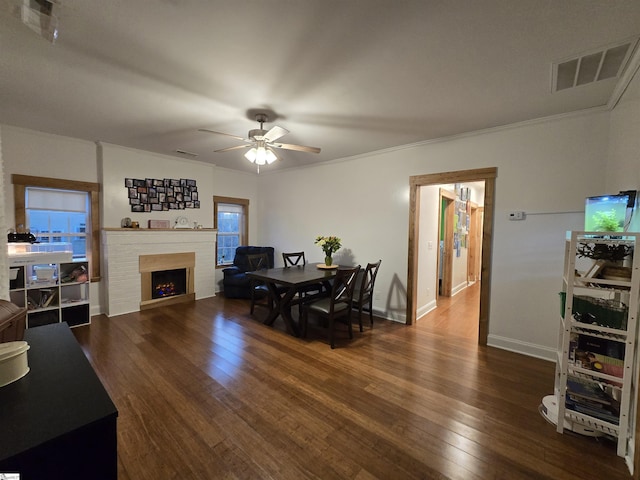 dining space featuring dark wood-type flooring, ceiling fan, and ornamental molding