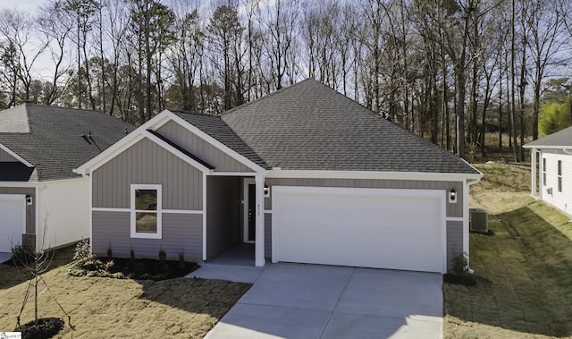 view of front of house with central AC unit and a garage