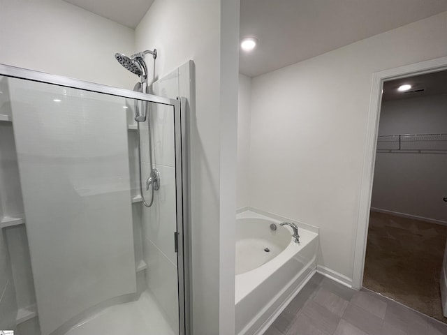 bathroom with separate shower and tub