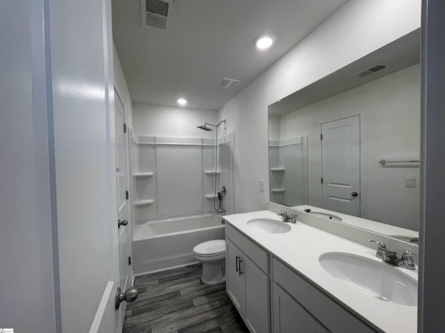 full bathroom with shower / bathtub combination, hardwood / wood-style floors, vanity, and toilet