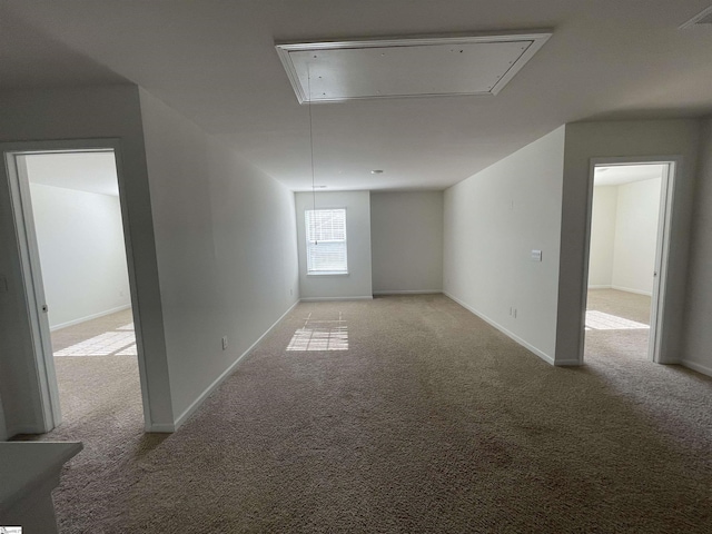 unfurnished room featuring light carpet