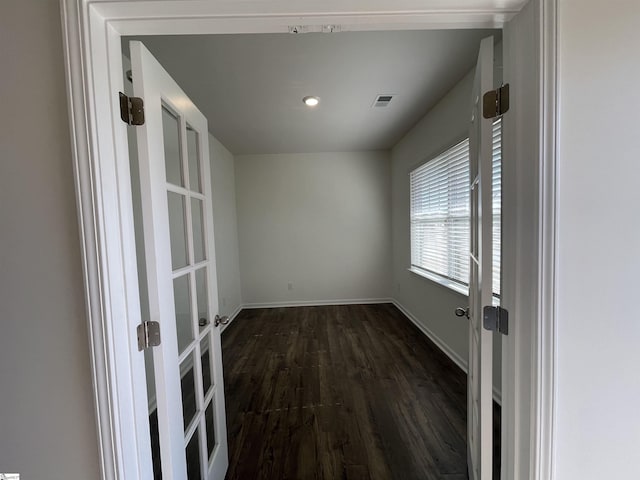 unfurnished room with dark hardwood / wood-style floors