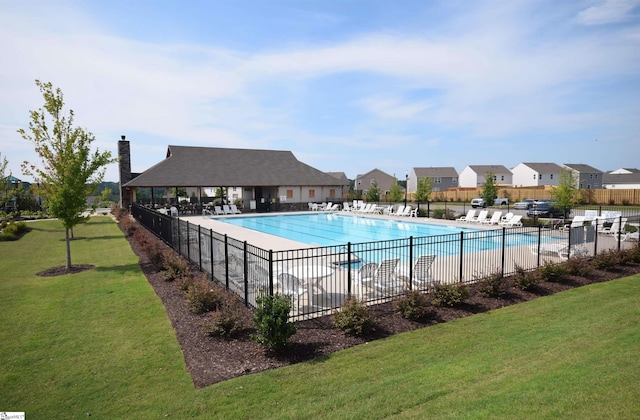 view of pool with a lawn and a patio