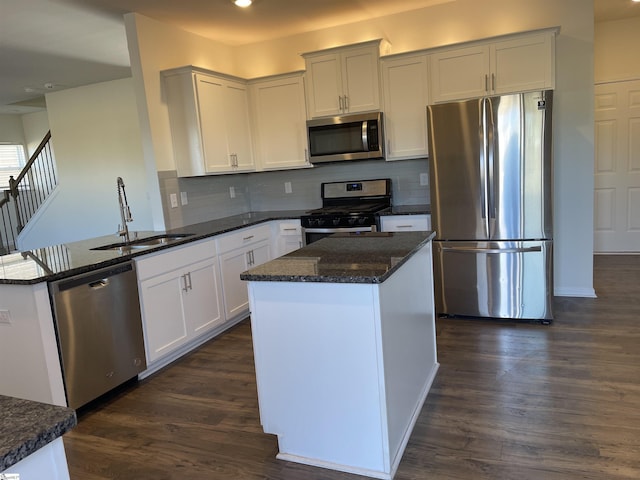 kitchen with sink, white cabinetry, dark stone countertops, and appliances with stainless steel finishes