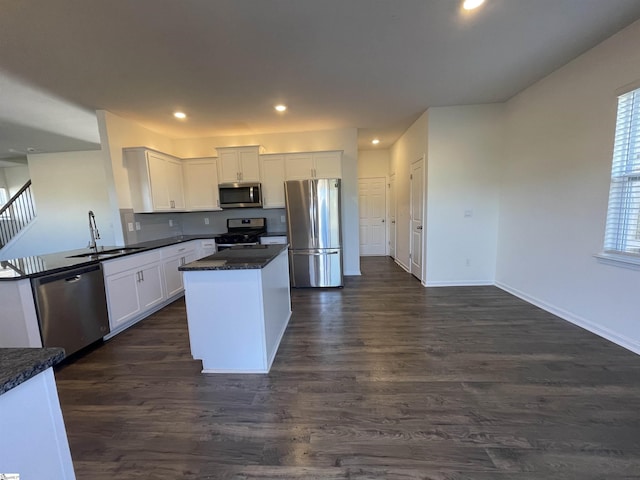 kitchen featuring sink, stainless steel appliances, white cabinetry, and dark hardwood / wood-style floors