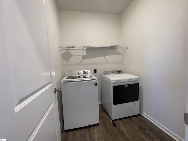 laundry area featuring dark wood-type flooring and washer and dryer