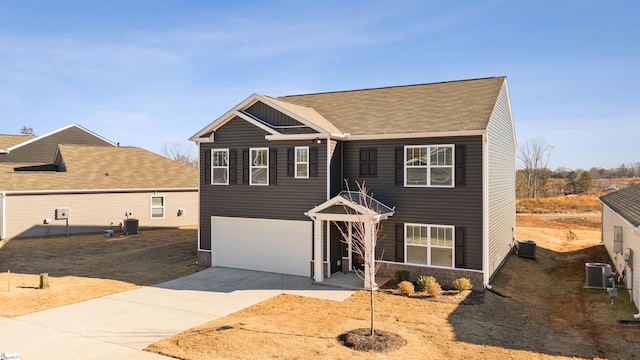 view of front of house with driveway, an attached garage, and cooling unit