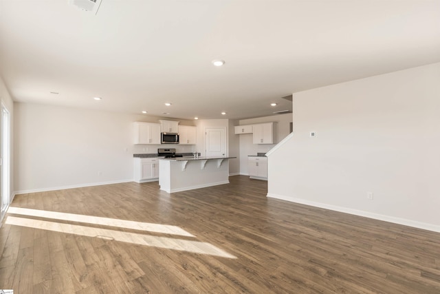 unfurnished living room featuring hardwood / wood-style flooring