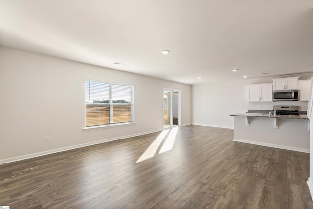 unfurnished living room with dark hardwood / wood-style floors