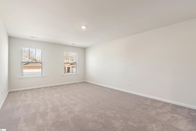 empty room featuring light carpet