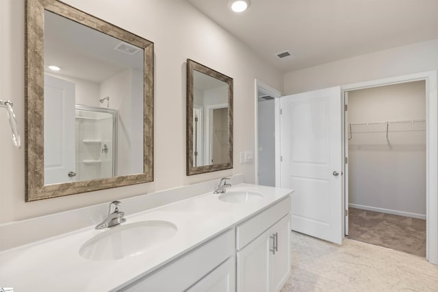 bathroom featuring vanity and a shower with shower door