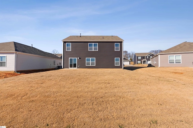 back of house with a yard