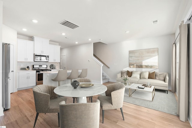 dining space with light wood-type flooring